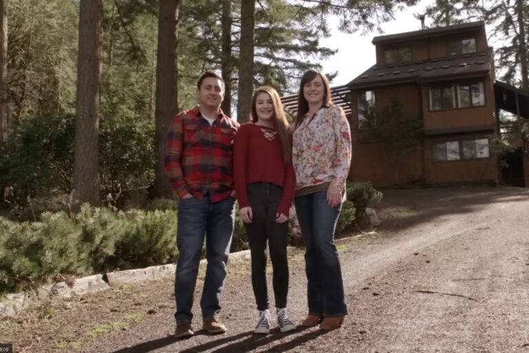 foster family standing outside their home