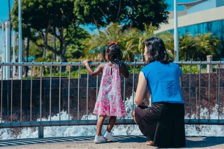 woman with child looking out over fountain